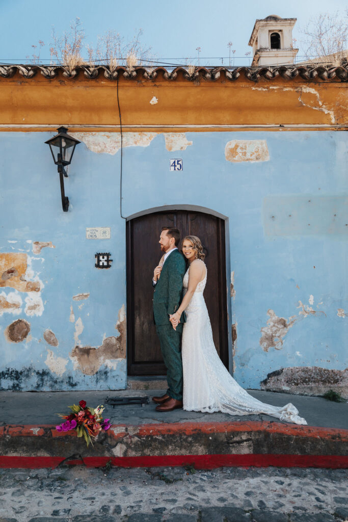 Colorful backdrop enhances the love and happiness of a destination wedding portrait in Antigua Guatemala